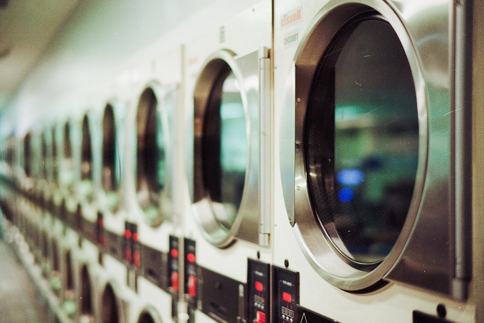 A row of commercial washing machines