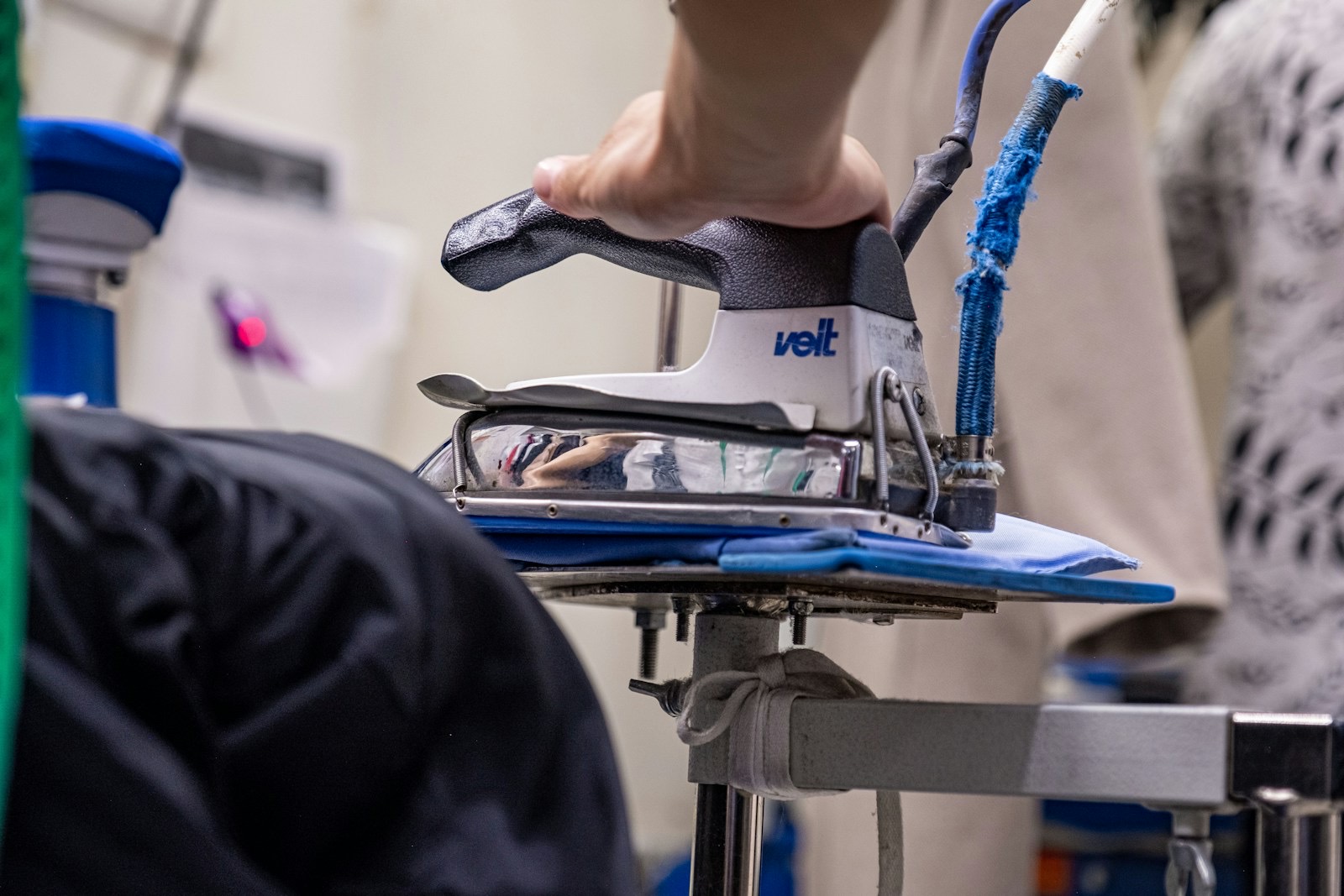 A professional steam iron pressing a garment